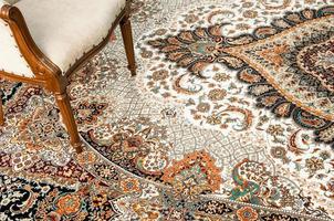 antique chair on the decorated oriental carpet photo