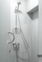 Shower cabin with a watering can, close-up photo