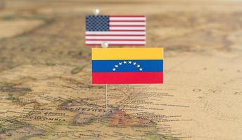 Flags of the USA and Venezuela on the world map. Conceptual photo, politics and world order photo