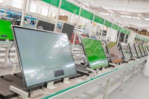 line conveyor assembly and testing televisions in a workshop photo
