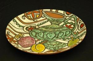 oriental antique ceramic plate on a black background photo