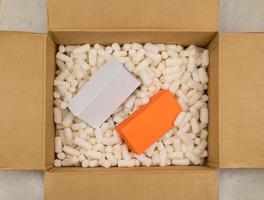 Cardboard box with styrofoam filler for safe packaging. Gift package. Top view photo