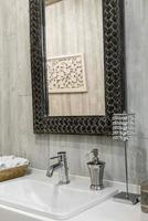 Closeup of a washbasin with a faucet in the bathroom photo