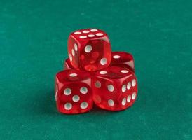 group of red playing dice on a green background, isolated photo