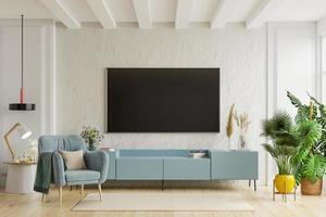 TV on the cabinet in modern living room with armchair on plaster wall background. photo