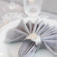 Beautiful table setting with Christmas decorations. Silver colors