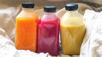 Healthy drink Juice in a bottle on linen background photo