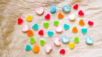 Heart Colorful sweets. Lollipops and candies. Top view background photo