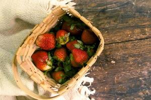 Strawberry in woven basket. Fresh strawberry. Red strawberry. Strawberry Juice. Wooden table background