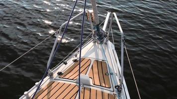 The bow of the yacht floats on the waves on a sunny day video