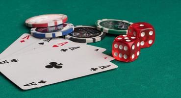 Poker chips, cards and dice on a green background. The concept of gambling and entertainment. Casino and poker photo