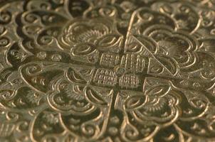 Eastern engraving on bronze, closeup photo