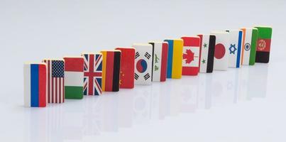 Domino effect with tiles of flags of different countries of the world. conceptual photo, political games photo