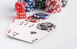 Poker chips, cards and dice on a white background. The concept of gambling and entertainment. Casino and poker photo