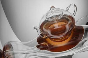 transparent teapot with tea on the reflective surface. distorted reflection