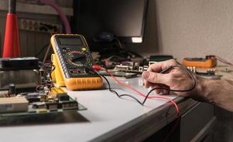 electronics technician is testing a computer chip. PC repair