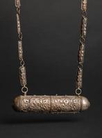 ancient antique pendant on black background. Middle Asian vintage jewelry photo