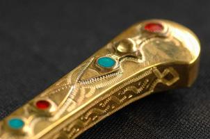 Decorative oriental knife decorated with precious gemstones photo