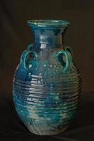 oriental antique ceramic vase on a black background closeup photo
