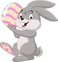 Cartoon little bunny holding Easter egg vector