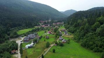 Aerial view on the small village near mountains video
