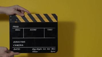 Clapper board. Close up hand and film making clapperboard isolated on background video