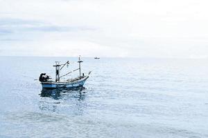 watercolor painting wooden boat with fishing rod inside floating on water . soft blue sea and sky.holiday idea photo