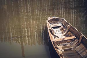 Lonely old wooden boat on the lake suburban traditional culture lifestyle