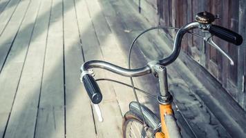 Bicycle handle bar close up. Vintage filter. wooden floor background. Good old day concept. Holiday idea