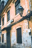 Street view on the beautiful old buildings with Portuguese style on old orange painted the facades . Macau China photo