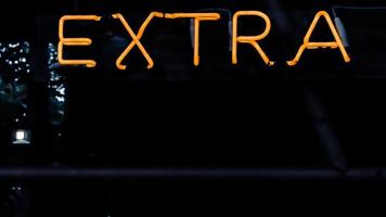 Extra word light signs .glowing neon bar alphabet on the dark background photo