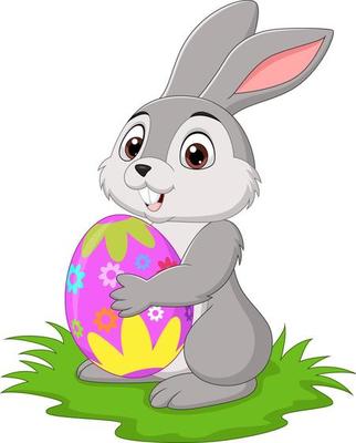 Cartoon little rabbit holding easter egg in the grass