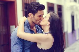 Young couple kissing in the street photo