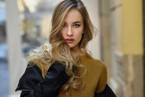 Beautiful blonde russian woman in urban background photo