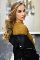 Beautiful blonde russian woman in urban background photo