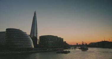 London skyline on Thames river with Shard in the background in sunset time, time lapse