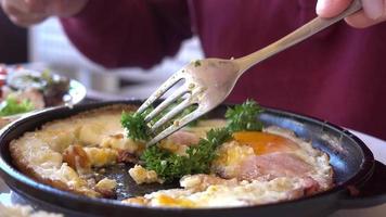 Man Eating Traditional Breakfast With Fried Eggs, Toast and Salad video