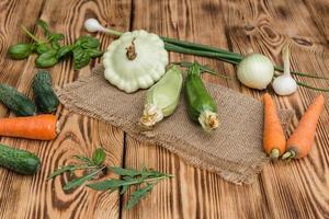 A set of vegetables on a wooden cutting board photo