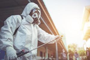 Health workers wear PPE, spraying disinfectants to prevent the spread of germs or coronavirus. photo