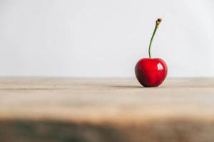 Fresh ripe cherrie on the wooden table background. Copy, empty space for text photo