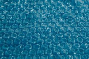 Packaging with air bubbles on a blue background. Bubble wrap texture, packaging, air bubble film. Copy, empty space for text photo