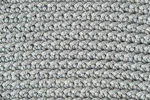 Gray knitted fabric texture background. Top view. Copy, empty space for text photo