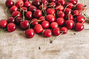Fresh ripe cherries on wooden background. Copy, empty space for text photo