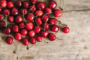 Fresh ripe cherries on wooden background.Top view. Copy, empty space for text