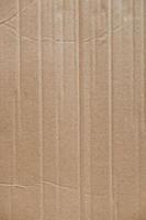 Crumpled corrugated cardboard surface texture background. Seamless crumpled brown paper textured backdrop. Top view. Copy, empty space for text