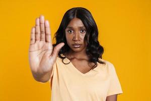 Serious African woman showing stop with hand