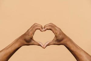 African male hands showing a heart shape photo