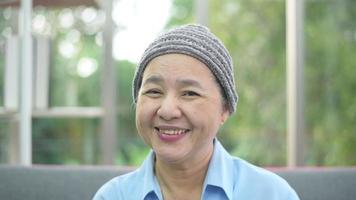 Headshot of smiling cancer woman in home video