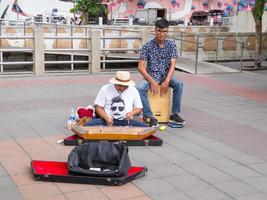 Saphan Taksin Pier BANGKOKTHAILAND16 AUGUST 2018 Two musicians are playing music for a donation. on16 AUGUST 2018 in Thailand. photo