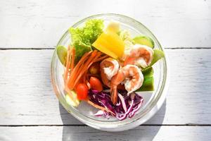 Salad vegetable breakfast in the morning - salad shrimp with fruit and fresh lettuce tomato carrot bell pepper on bowl on table healthy food eating concept photo